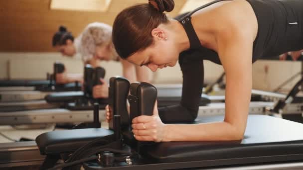Group Active Woman Making Plank Exercise While Workout Reformer Bed — Video