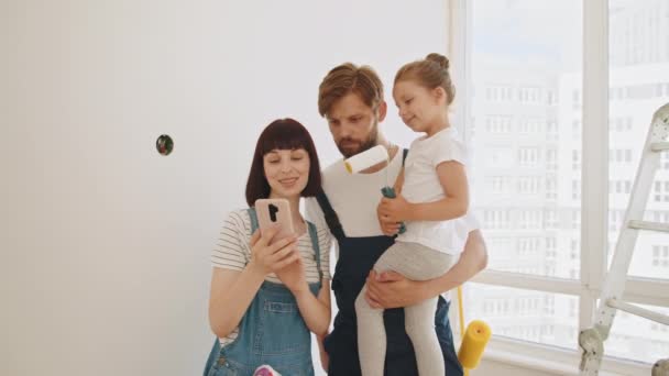 Joyful Young Caring Parents Little Cute Preschool Girl Tapping Browsing — Stock Video