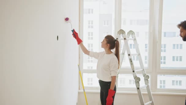 Couple Decorating Room New Home Painting Wall Together Cheerful Couple — Wideo stockowe