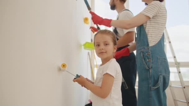Happy Family Mother Father Baby Daughter Doing Repairs Paint Wall — Stock video