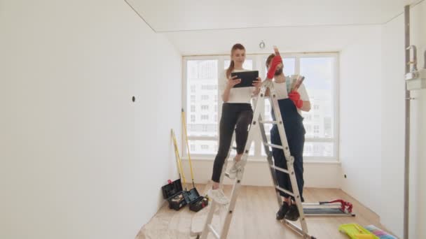 Couple Discussing Plan Apartment Renovation Tablet Computer Young Couple Choosing — Wideo stockowe