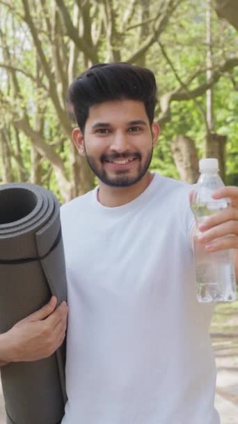 Vertical Screen Cheerful Muslim Man Activewear Holding Yoga Mat Bottle — Stock videók
