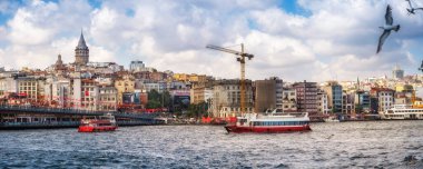 Istanbul, Turkey July 14, 2021, View of the Galata Tower, Bosporus, Galata Bridge, Restaurants and the urban river transport. Ferries float at the Bosphorus