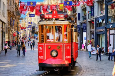 Istanbul, Turkey - July 18, 2019, The Taksim Tunel Nostalgia. Tram trundles along the istiklal street and people at istiklal avenue. Street with old buildings with cafes, restaurants and shops