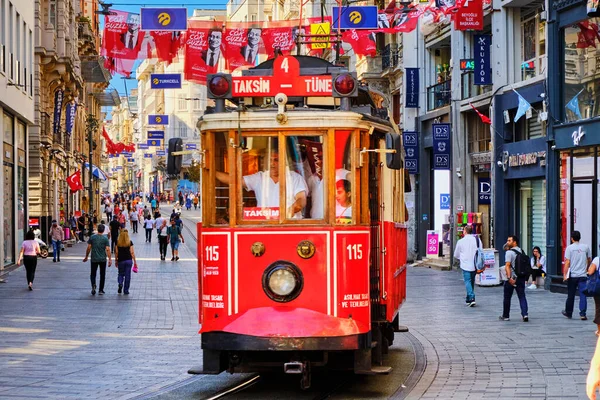Istanbul, Turkey - July 18, 2019, The Taksim Tunel Nostalgia. Tram trundles along the istiklal street and people at istiklal avenue. Street with old buildings with cafes, restaurants and shops