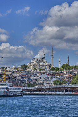 İstanbul, Türkiye - 19 Temmuz 2022, Pier Eminonia ve kentin Avrupa kesimi, Süleyman Camii, Galata Köprüsü ve Boğazı manzaralı. Şehrin tarihi merkezinde otelleri ve restoranları olan eski binalar. Paslı feribotlar