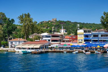 Pier Anadolu Anadolu Kavagi on the Bosphorus Strait in the Asian part of Istanbul, a small town with fish restaurants, souvenir shops and a fortress of Yoros clipart