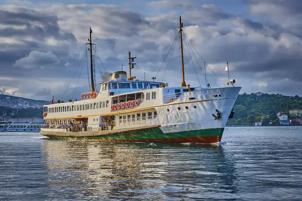 stock image Istanbul, Turkey, A ferry sails along the Bosphorus in the Besiktas area near the Ortakoy pier and the Bosphorus bridge