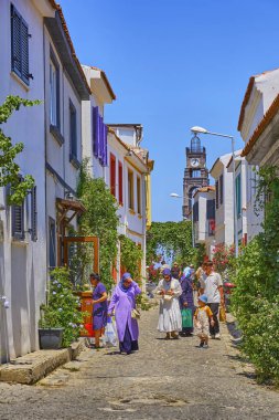 Bozcaada, Turkey, July 17, 2024, Colorful streets with old beautiful houses and bright flowers, tourists walk along the streets of the island clipart