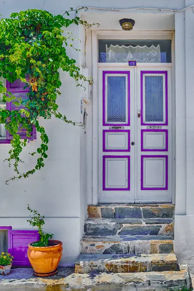 stock image Bozcaada, Turkey, Colorful streets with old beautiful houses and bright flowers, View of the door with decorations