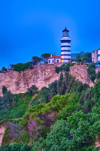 stock image Sile, Turkey, Lighthouse on the rocky shore of the Black Sea against the blue sky in the evening after sunset. Popular historical place of the city