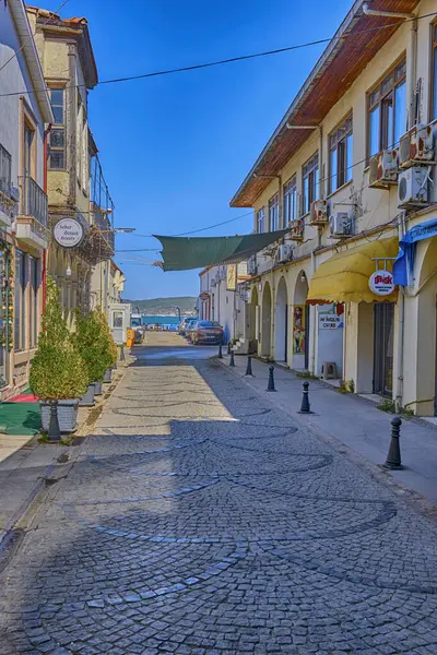 Ayvalik, Türkiye, 13 Temmuz 2025, Renkli evleri, kafeleri ve dükkanları olan kentin merkezindeki sokaklar, insanlar sokaklarda yürüyor