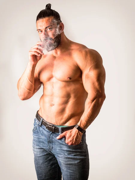 Handsome Shirtless Muscular Male Bodybuilder Smoking Cigarette Blowing Smoke Studio — Stock Photo, Image