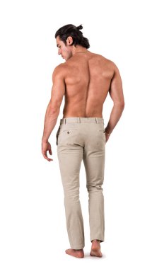 Full figure back shot of handsome shirtless athletic young man in pants, looking at camera in studio shot, isolated on white background
