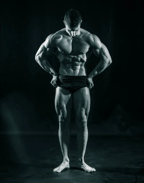 Handsome Young Bodybuilder Doing Classic Bodybuilding Pose Looking Away Greenish — Fotografia de Stock