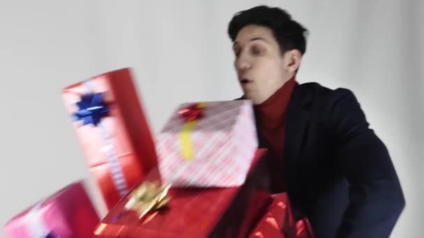 Portrait Young Man Dropping Pile Presents Gift Boxes Studio Shot — Stock Video