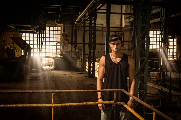 Young Male Casual Clothes Cap Standing Abandoned Industrial Building Metal — Stock Photo, Image