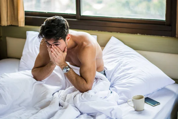 Young Handsome Shirtless Sleepy Man, Lying in Bed Yawning as He\'s Waking Up