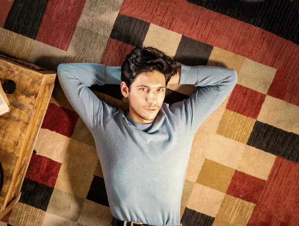 Cool Dark Haired Handsome Young Man Laying Floor Colorful Rug — Stock Photo, Image