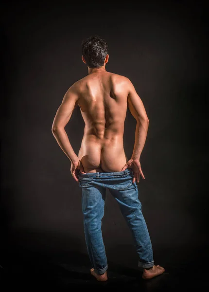 Muscular Man Pulling Jeans Show His Butt Studio Shot — Stock Photo, Image