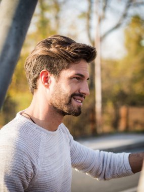 Avrupa 'da şehir merkezinde yakışıklı bir genç adam ayakta duruyor.