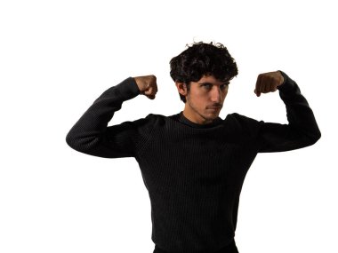 A man wearing a black sweater and pants is shown flexing his muscles in an assertive pose. The contrast of the black clothing against his toned physique enhances the visual impact of the image. clipart
