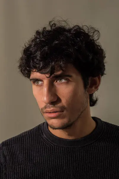 stock image A close up, head shot of a handsome young man with green eyeswearing a black shirt