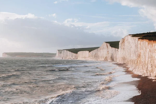 stock image Waves hitting the beach by Seven Sisters chalk cliffs, one of the longest stretches of undeveloped coastline on the south coast, East Sussex, UK.