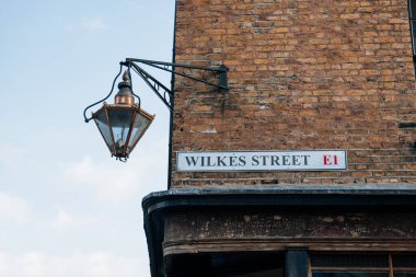 Street name sign on a building on Wilkes Street in Spitalfields, East London, UK.