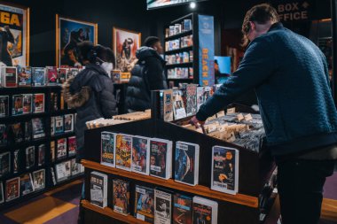 New York, USA - November 25, 2022: Visitors browsing free DVD and VHS rentals at Kims Video in Alamo Drafthouse Lower Manhattan. Kims Video is back in NYC after 12 years in Italy.