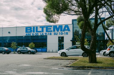 Helsinki, Finlandiya - 22 Ağustos 2022: BILTEMA mağazası. Binanın ana girişinin üstündeki mavi işaret. Mağazanın dış cephesinde araba parketme