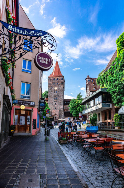 Nuremberg, Germany - July 26, 2023: Street cafes, embankment in old town of Nuremberg, Bavaria. vertical photo