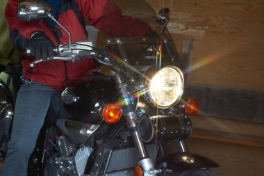 Bu kişi motosikletini garajından çıkaracak. O, kırsalda bir yürüyüşe çıkmak için gidiyor. Ulverton, Quebec, Kanada, 1 Mayıs 2021.