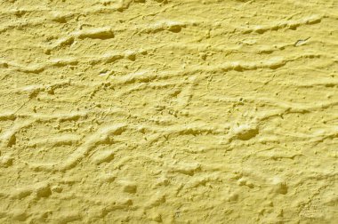 Yellow wall background. Close up image of a yellow wall.