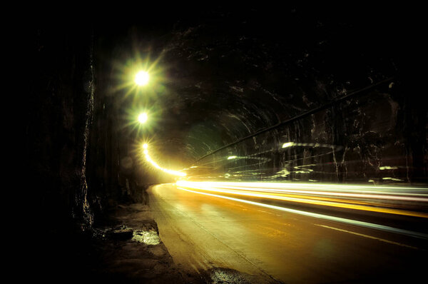 Old dark damp tunnel with light trails.