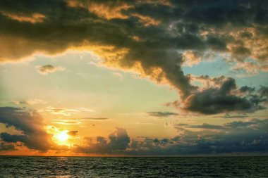 Akşamları deniz manzarası. Güzel bulutlu gün batımı gökyüzü.