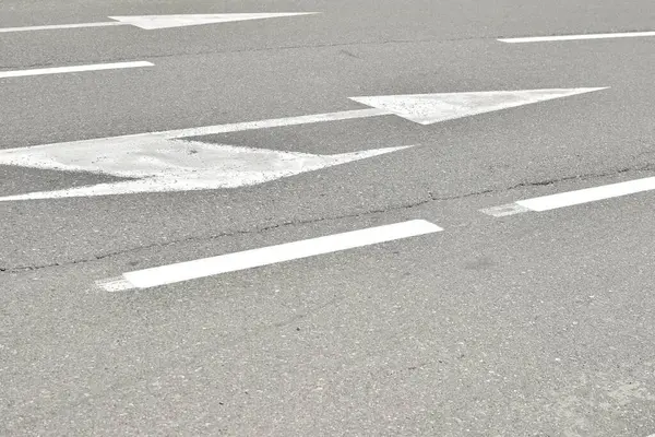 stock image White arrows and directional lines on the road