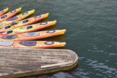 Copenhagen, Denmark. October 28, 2024. Orange kayaks tied together clipart