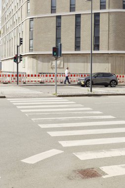 Copenhagen, Denmark. October 28, 2024. Street view with a car and a walking man in Copenhagen. clipart