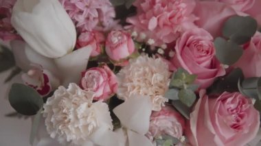 Elegant bouquet of pink roses and other flowers captured in beautiful slow-motion footage. Ideal for a wedding or anniversary celebration. 4k resolution, pan shot. 