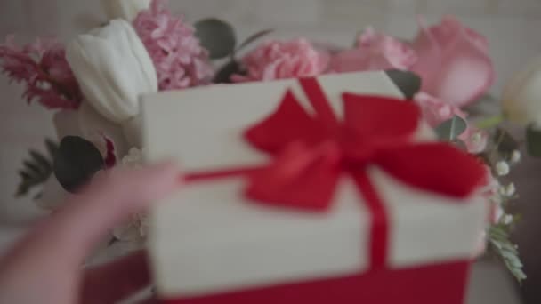 Man Gives Gift Box Red Ribbon Background Stunning Roses Other — Vídeo de Stock
