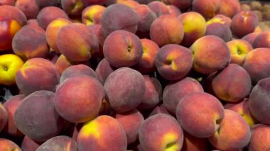 Çiftçi pazarında yeşil plastik sepette taze şeftaliler. Yüksek kalite 4k video.