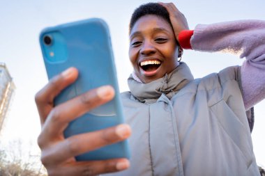 Excited student checking exam results online on smartphone. Happy for college grades end of semester. High quality photo