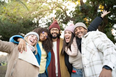 Happy, diverse and laughing group of colleagues taking a photo or picture together outdoors. Portrait of a fun team of students or friends posing outside. High quality photo
