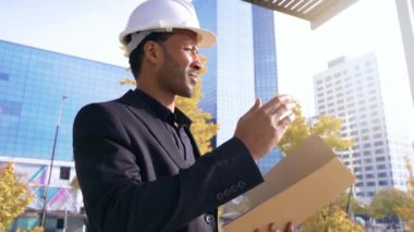Engineer architect inspect and authorize work construction site. Contractor checking issues with a blueprint, papers and safety helmet. High quality 4k footage