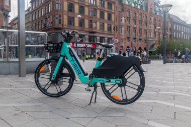 Copenhagen, Denmark - July 26, 2022: Tier e-bike in city center of Copenhagen. TIER electric bike. clipart