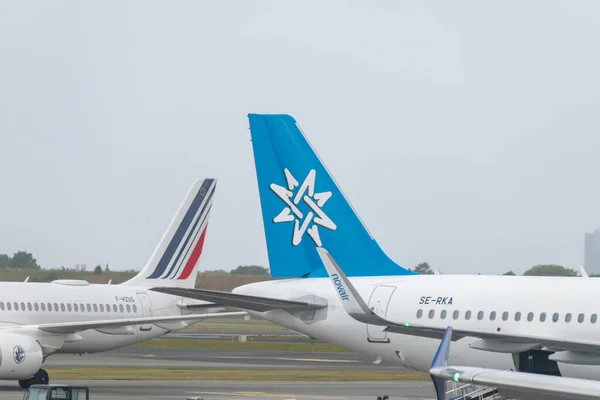 stock image Copenhagen, Denmark - July 27, 2022: Plane Tail of Swedish airline Novair and Air France in background.