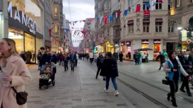 Istanbul, Turkey - December 10, 2022: People walking at the Independence Avenue or Istiklal Caddesi street. One of most popular pedestrian street in Istanbul.