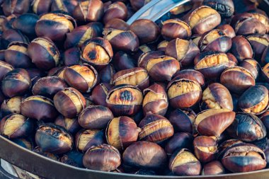 Eat roasted chestnuts. Roasted chestnuts for sale. clipart