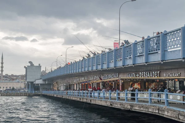 Istanbul, Turkey - December 11, 2022: Galata Bridge with fishermen in the morning.